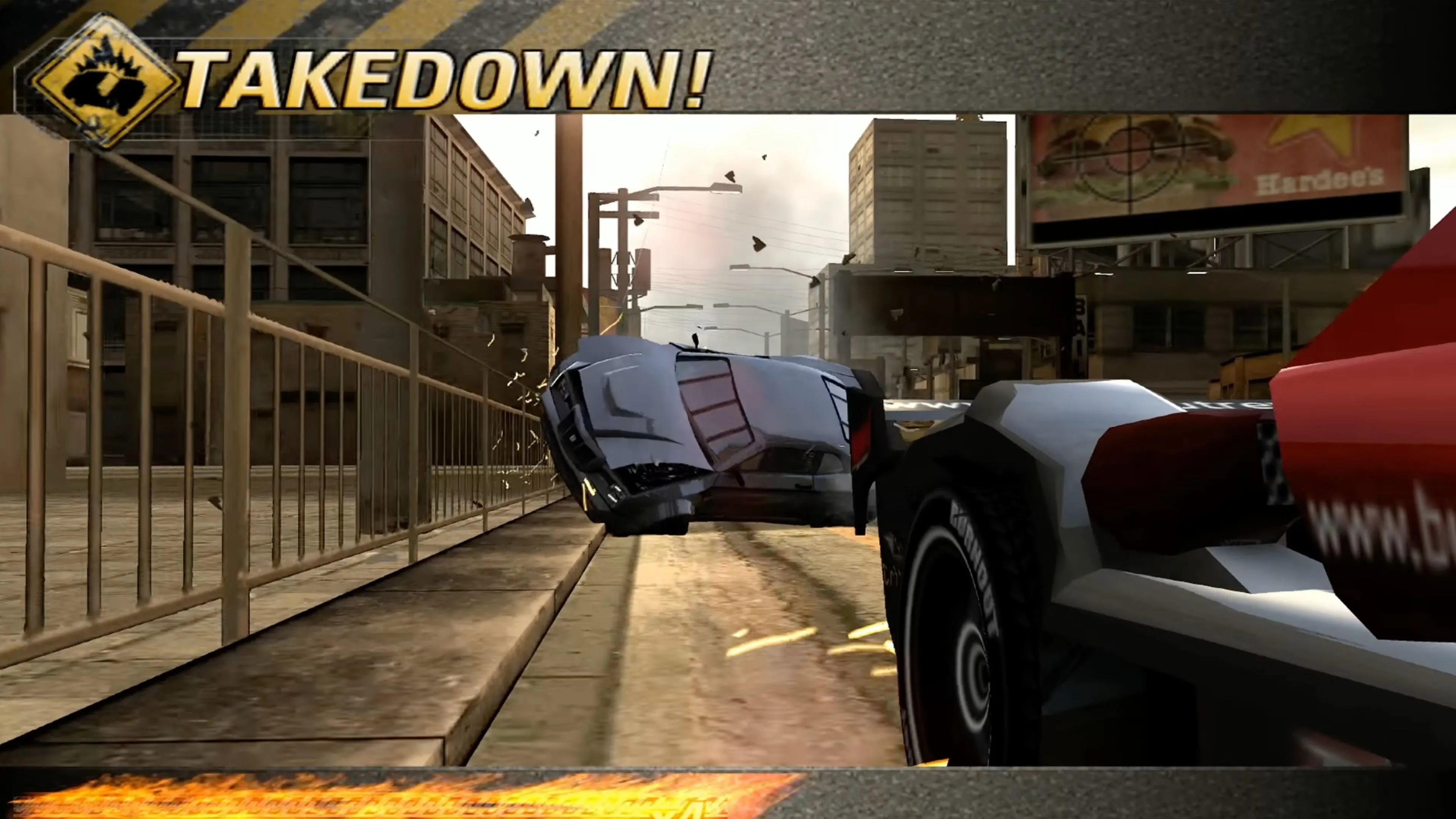 Cảnh Takedown một đối thủ trong game Burnout Revenge trên đường đua.