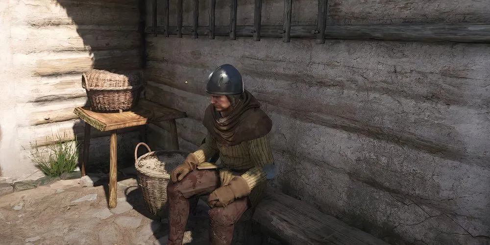 Drat đang ngồi suy tư trước khi tiết lộ thông tin về Mikush trong Kingdom Come Deliverance 2