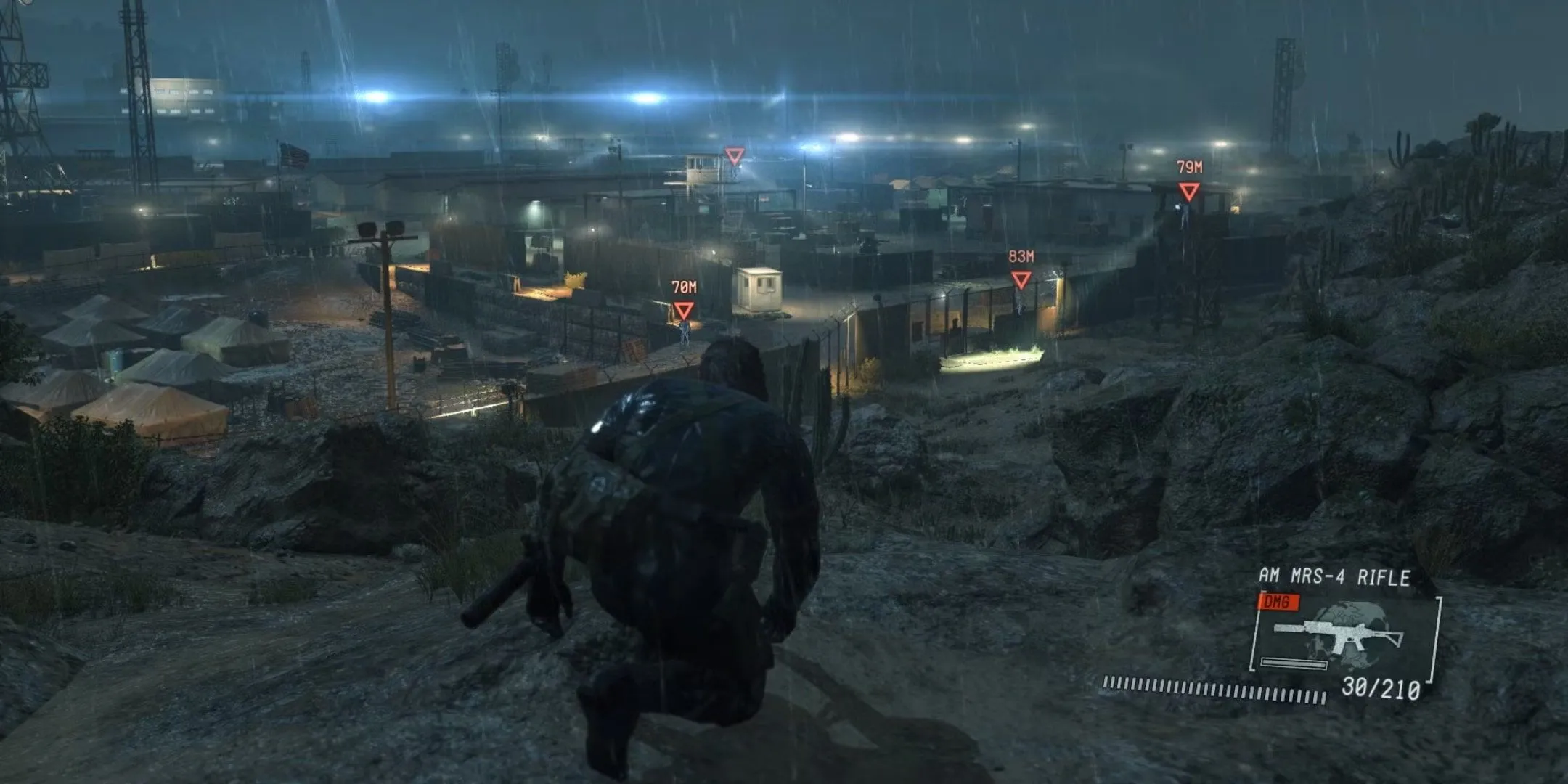Snake nhìn xuống một khu trại trong Metal Gear Solid 5 Ground Zeroes