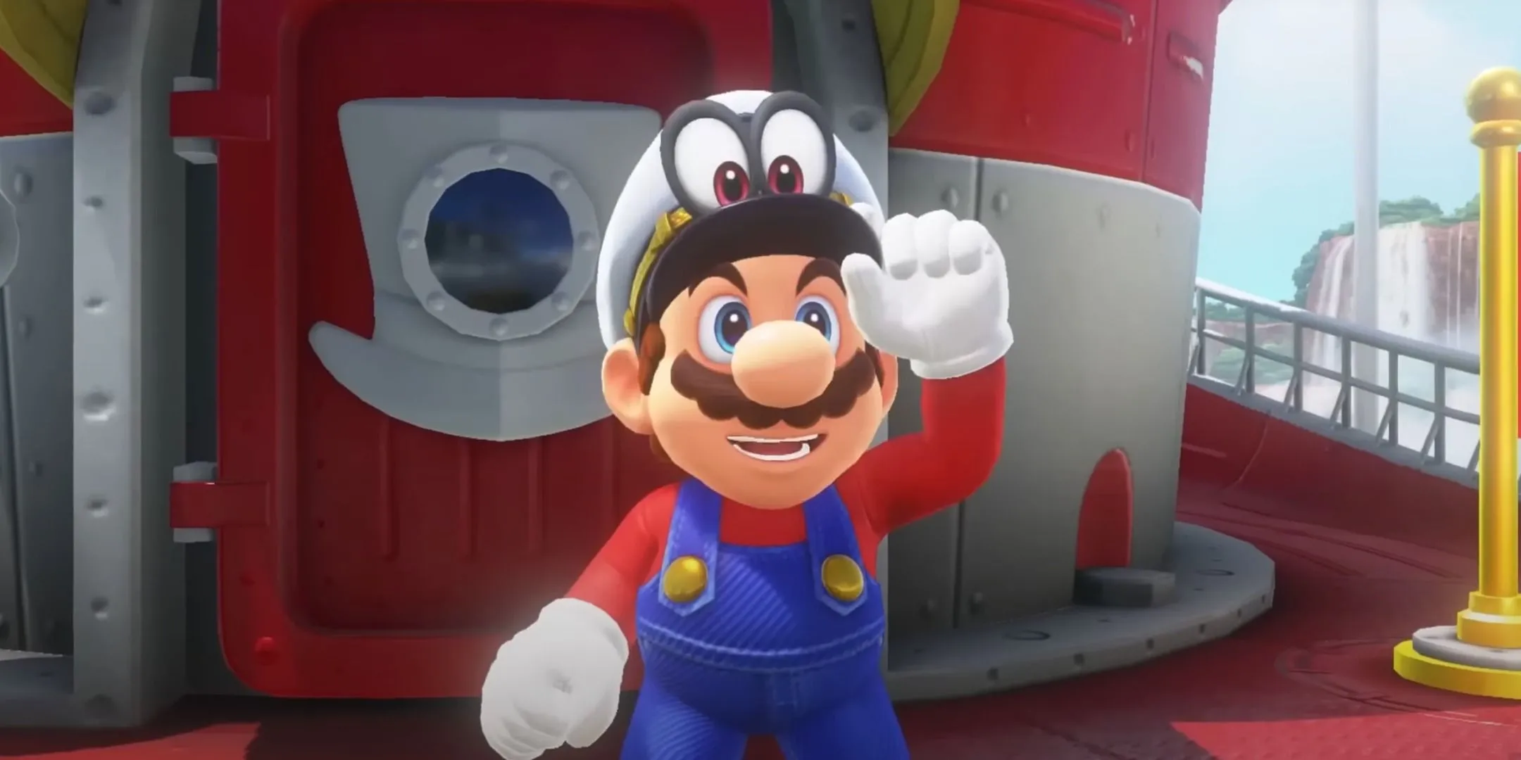 Mario và Cappy trên con tàu trong Super Mario Odyssey, Mario với ria mép và bụng béo, trông như một người đàn ông trung niên dù chỉ 24-25 tuổi.
