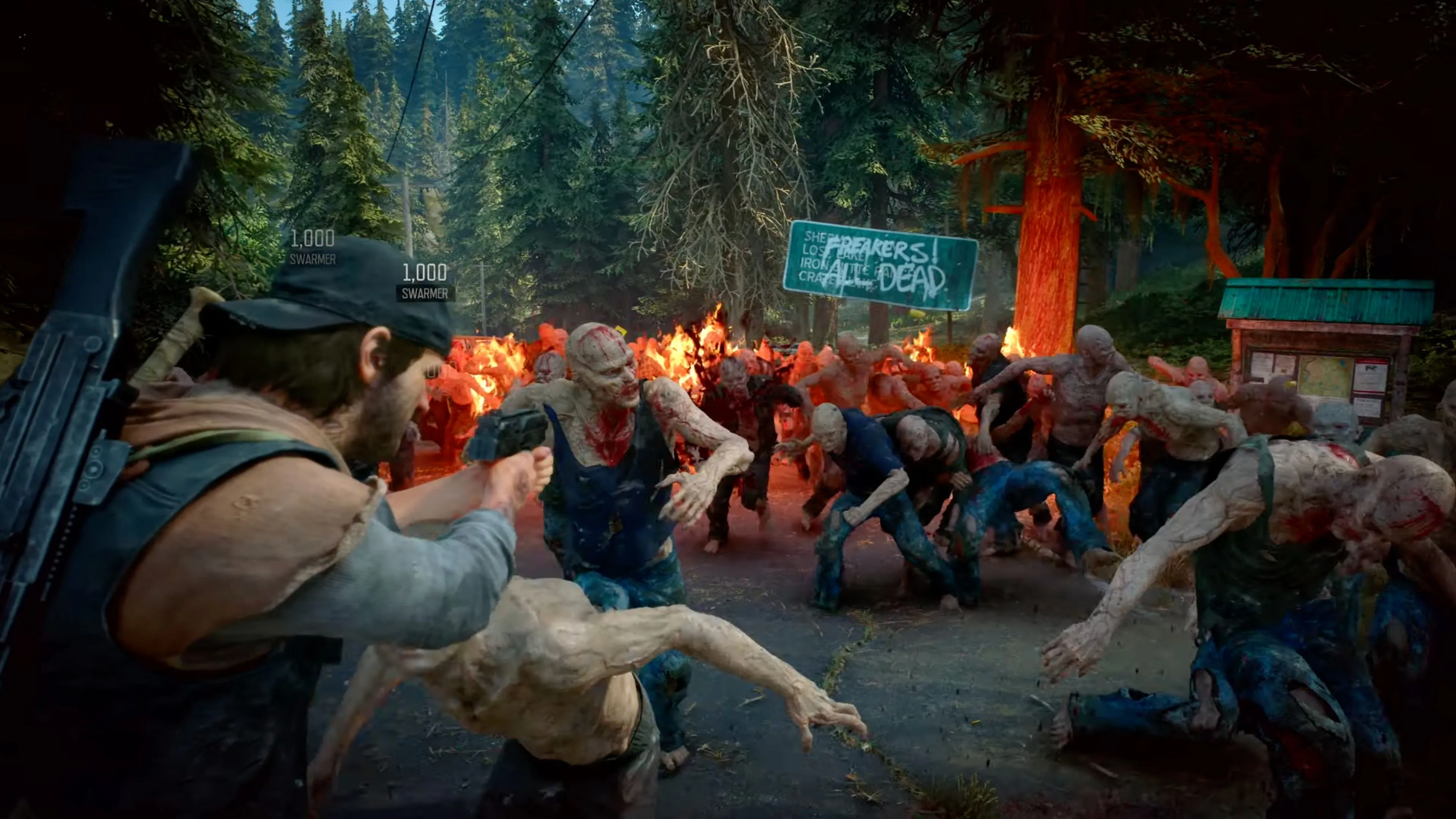 Nhân vật chính Deacon St. John trên chiếc xe máy của mình trong thế giới hậu tận thế của Days Gone Remastered, khung cảnh hùng vĩ nhưng hoang tàn.