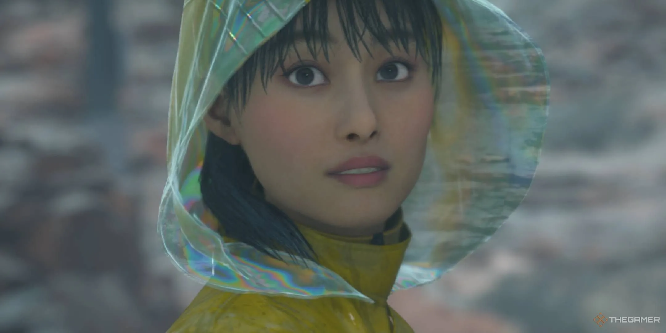 Rainy với chiếc mũ trùm đầu, bị ảnh hưởng bởi Timefall, trong Death Stranding 2: On The Beach